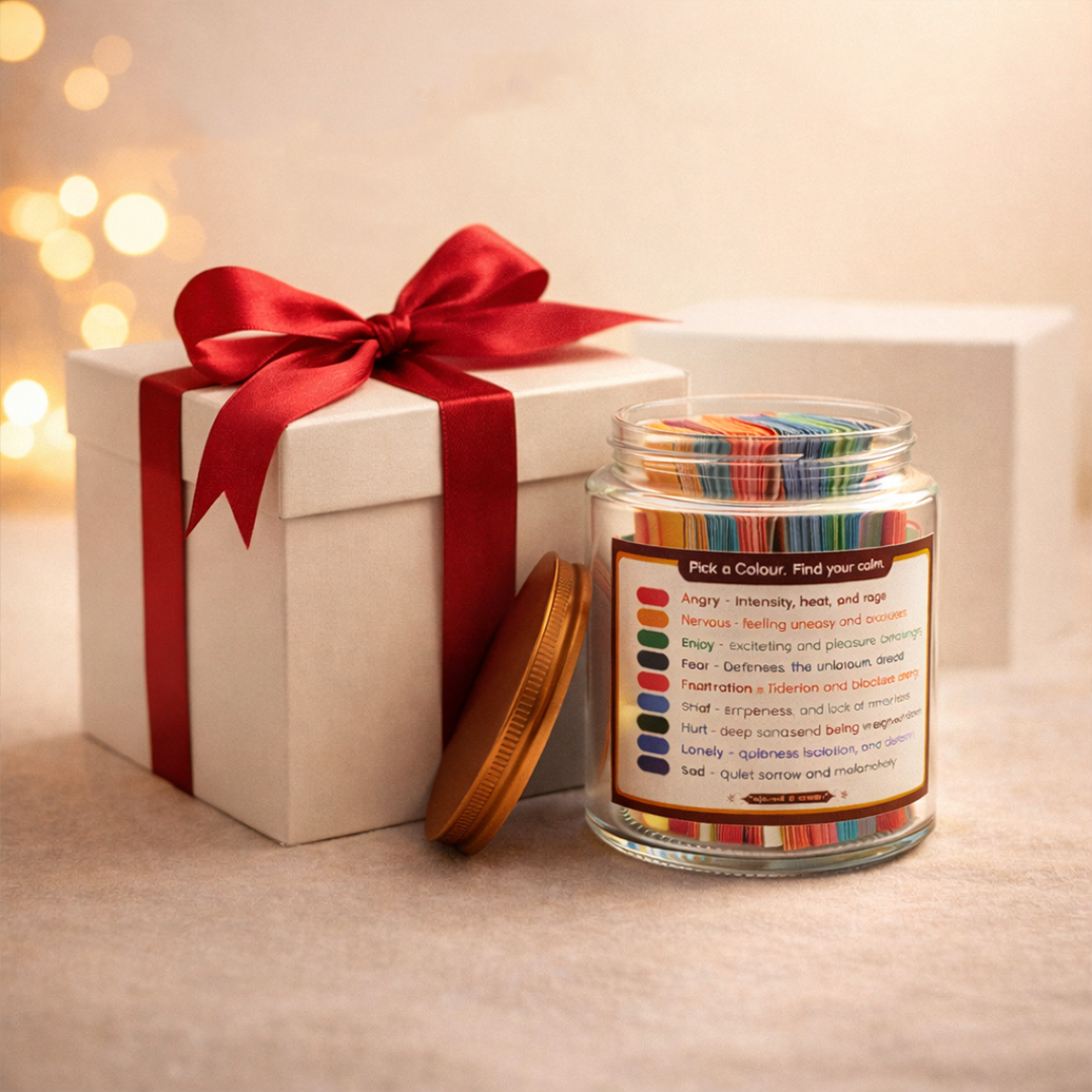 Colorful emotion cards in jar beside gift box with red ribbon, ideal for spiritual calm and mindfulness